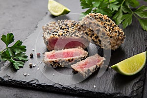 Grilled sesame tuna steak on black background