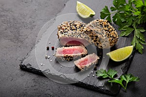 Grilled sesame tuna steak on black background