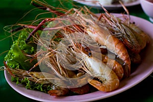 Grilled Shrimp and burn on green slad., sea food.