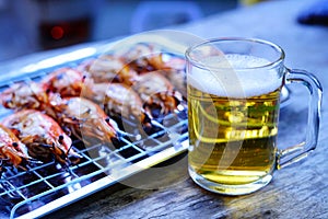 Grilled shrimp Giant freshwater River prawn grilling with charcoal at home, Natural Light in the evening with Beer. Bangkok,