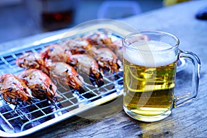 Grilled shrimp Giant freshwater River prawn grilling with charcoal at home, Natural Light in the evening with Beer. Bangkok,