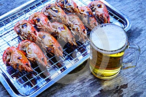 Grilled shrimp Giant freshwater River prawn grilling with charcoal at home, Natural Light in the evening with Beer. Bangkok,