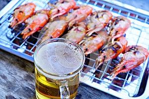 Grilled shrimp Giant freshwater River prawn grilling with charcoal at home, Natural Light in the evening with Beer. Bangkok,