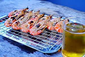 Grilled shrimp Giant freshwater River prawn grilling with charcoal at home, Natural Light in the evening with Beer. Bangkok,