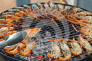 Grilled shrimp on a steel frame with hot fire