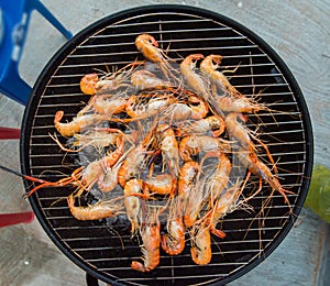 Grilled shrimp on a steel frame with hot fire