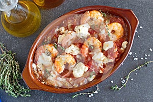 Grilled shrimps covered with feta cheese, tomatosauce