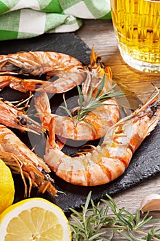 Grilled shrimps on stone plate and beer mug