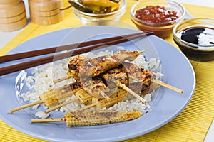 Grilled skewed chicken with baby corn and rice