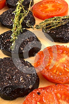 Grilled slice black pudding and tomato with thyme