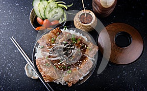 Grilled slice pork with charcoal flame set on rice bowl in Japan