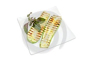 Grilled sliced vegetable marrows on the square white dish