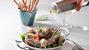 Grilled snails , cooking barbecue seafood with pesto sauce. French cuisine. Vertical video, ideal for social media and