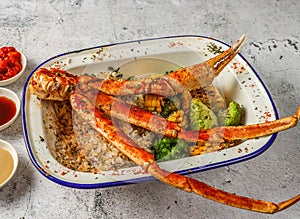 Grilled snow crab cluster with fried rice, grilled corn and broccoli served in isolated on grey background top view of singaporean