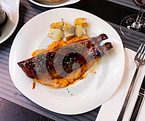 Pork ribs with BBQ sauce and sweet potato photo