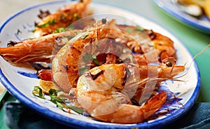 Grilled spicy pink prawns with fresh herbs photo