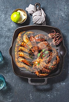 Grilled spimps, squids and octopus in cast iron grill pan