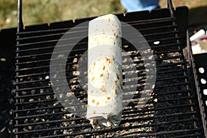 Grilled staffed roll with lemon on grill bar closeup photo