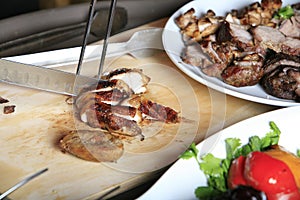 Grilled steak being cut on a cutting board