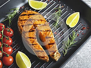 grilled steak fish salmon  trout in a grill pan  spices  rosemary  tomato  close up