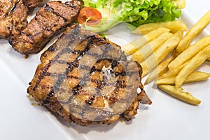 Grilled steak, French fries and vegetables