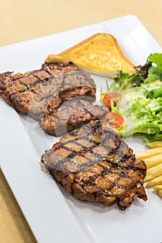 Grilled steak, French fries and vegetables