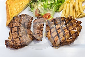 Grilled steak, French fries and vegetables