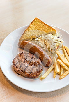 Grilled steak, French fries and vegetables