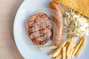 Grilled steak, French fries and vegetables