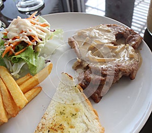 Grilled steak, French fries and vegetables.