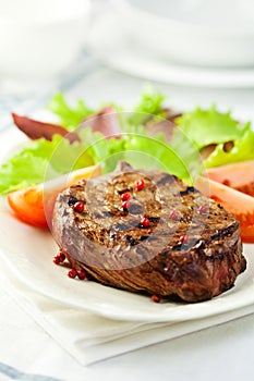 Grilled steak with pink pepper