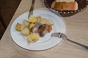 Grilled steak, potato and bread on a plate. bread on the table