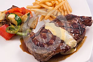 Grilled Steak served with Hollandaise sauce, fries, and stir fry / sauteed vegetable