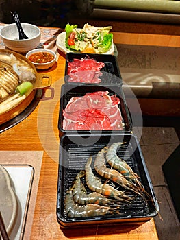 Grilled steak, shrimp, meat with vegetables and sauce. Shabu Shabu and Sukiyaki, Japanese food.