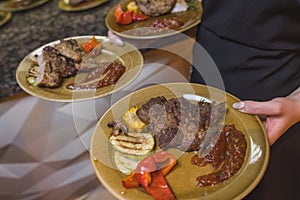 Grilled Steak Striploin and Pepper sauce on cutting board on dark wooden background.