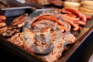 Grilled steak,traditional sousage and different tipe of meat. photo