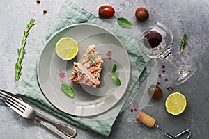 Grilled steak tuna with lime and red wine on a gray background. Top view, flat lay
