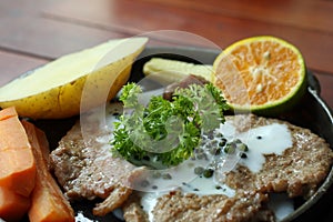 Grilled steaks, baked potatoes and vegetables