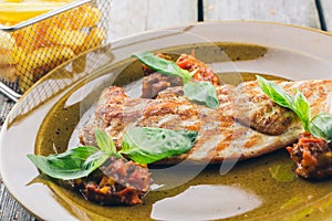 Grilled steaks and fries potatoes