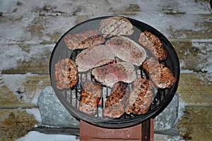 Grilled steaks on the grill in winter