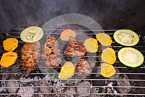 Grilled steaks and vegetables like sweet potatoes and zucchini cooked on the garden grill.