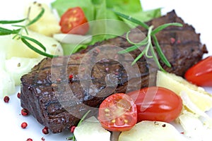 Grilled strip steak with tomato and salad