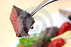 Grilled strip steak with tomato and salad