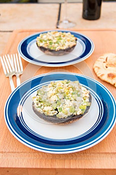 Grilled stuffed portobello mushrooms with feta cheese and scallions.