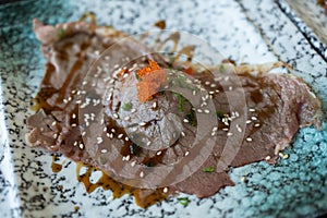 Grilled sushi wagyu beef with shoyu sauce on top with ebiko shrimp eggs and white sesame