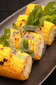 Grilled sweet corn on the black plate