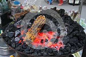 Grilled sweet corn on Charcoal.