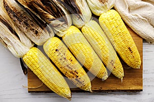 Grilled sweet corn on wooden board