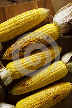 Grilled sweet corn on wooden board