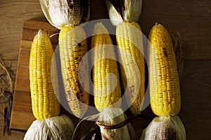 Grilled sweet corn on wooden board